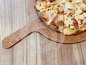 Delicious pizza served on wooden table