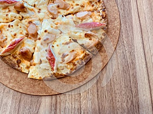 Delicious pizza served on wooden table