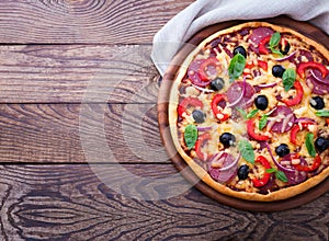 Delicious pizza served on wooden table top view