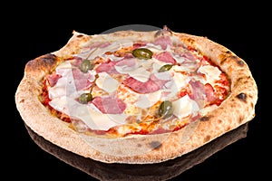 Delicious pizza with speck Cotto, mozzarella, Italian cheese and capers, with reflection photo