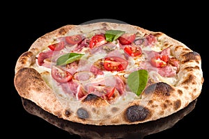 Delicious pizza with speck Cotto, mozzarella, sour cream, onion, tomatoes,  with reflection photo