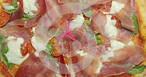 Delicious pizza surface with chease and meat rotating photo