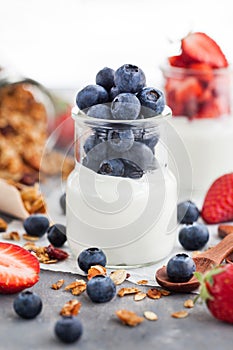 Delicious plain yogurt with fresh blueberry and strawberry in a