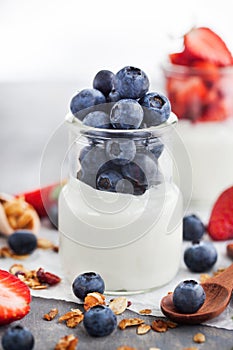 Delicious plain yogurt with fresh blueberry and strawberry in a