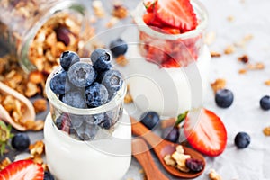 Delicious plain yogurt with fresh blueberry and strawberry in a