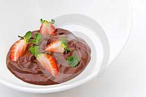 Delicious plate of chocolate cream with strawberries