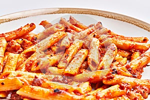 Delicious plate of italian macaroni with tomato sauce over isolated white background