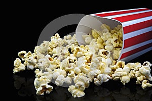Delicious popcorn that is ready to eat that is on a black background