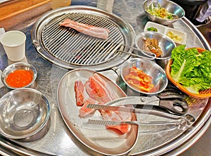 Delicious pork BBQ Pork belly grilled with kimchi and many side dishes big dinner meal in Seoul, South Korea