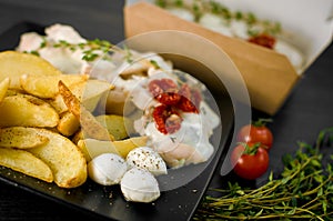 Delicious portion of rustic potatoes fillet with aromatic herbs