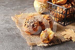 Delicious pumpkin muffins with sunflower seeds on table