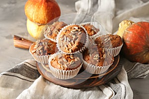 Delicious pumpkin muffins with sunflower seeds on table