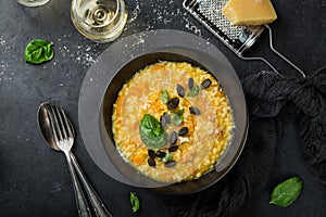 Delicious pumpkin risotto, black background