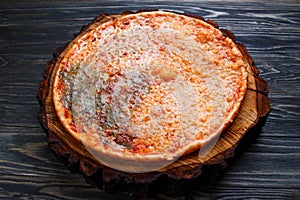 Delicious quattro formaggi pizza on rustic wooden background, se