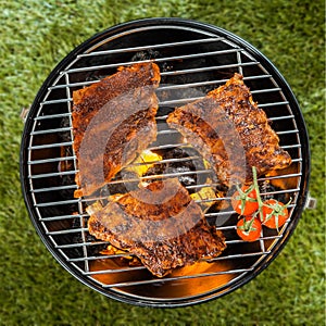 Delicious racks of rib grilling over a BBQ fire