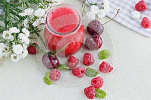 Delicious raspberry and sweet cherry smoothie or milk shake with fresh berries. Fresh yogurt with raspberry.