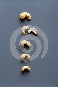 Delicious raw cashew nuts on grey background. Flatlay. Macro food photography