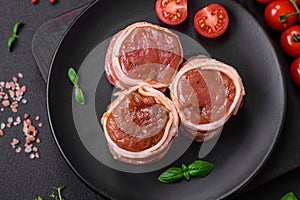 Delicious raw fresh pork or chicken meat rolls wrapped in bacon