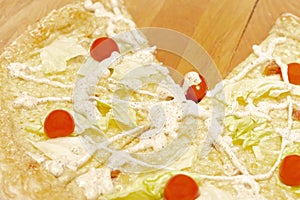 Delicious ready-made pizza with cabbage, tomato and cheese