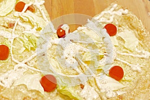 Delicious ready-made pizza with cabbage, tomato and cheese