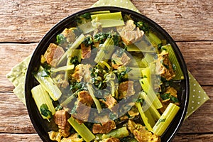 Delicious recipe for a Persian stew khoresht karafs of celery celery with beef, onions, mint and parsley close-up in a plate.