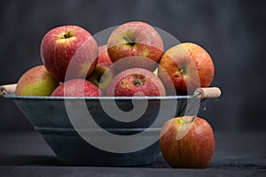 Delicious red apples in old metal washtub