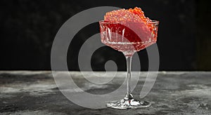 Delicious red caviar in bowl, Close-up salmon caviar. Delicatessen. Gourmet food. Seafood. appetizer, selective focus, place for