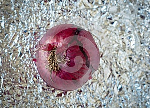 a delicious red onion over a tin paper