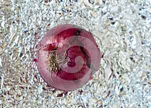 a delicious red onion over a tin paper