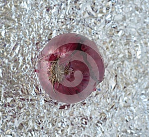 a delicious red onion over a tin paper