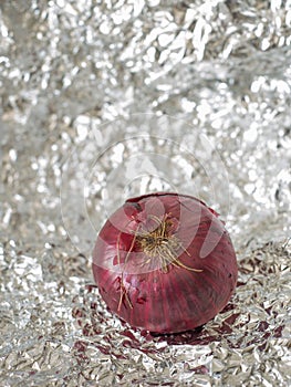 a delicious red onion over a tin paper