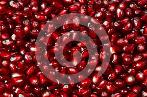 Delicious red ripe juicy pomegranate seed background texture.