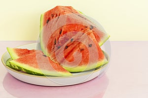 Delicious red sliced watermelon on a plate. Stock of fiber and fructose. Summer food concept