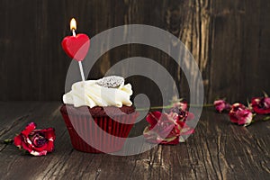 Delicious red velvet cupcake with burning candle
