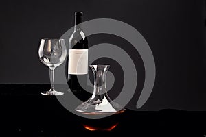 Delicious Red wine bottle and glass filled with wine on black background