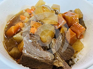Delicious red wine braised beef served over white rice