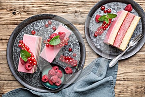 Delicious and refreshing juicy dessert, punch cake topped with sugar icing and fresh raspberries and red currants
