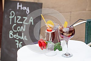 Delicious refreshing sangria wine on table in cafe, outdoors. Caption: