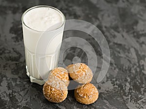 A delicious, refreshing summer drink, a milkshake made of milk and ice cream. Gingerbread on a dark table