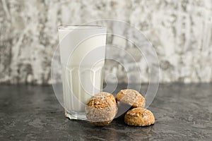 A delicious, refreshing summer drink, a milkshake made of milk and ice cream. Gingerbread on a dark table