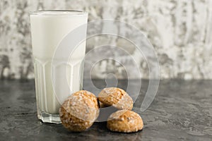 A delicious, refreshing summer drink, a milkshake made of milk and ice cream. Gingerbread on a dark table