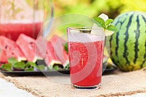 Delicious refreshing summer fruit - watermelon juice and slices on the table