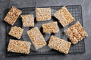 Delicious rice crispy treats on grey table, flat lay