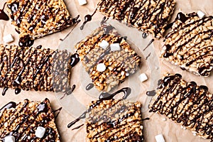Delicious rice crispy treats on parchment paper, flat lay