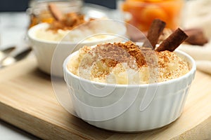 Delicious rice pudding with cinnamon on board, closeup