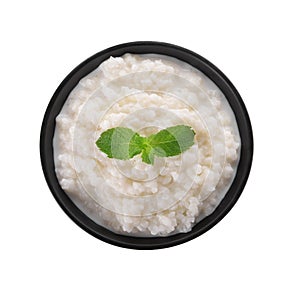 Delicious rice pudding with mint in bowl on white background