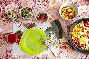 Delicious rich traditional Mediterranean breakfast includes tomatoes, cucumbers, eggs, olives, potatoes and juice.