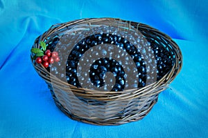 Delicious ripe blueberries in a wooden basket stands on table