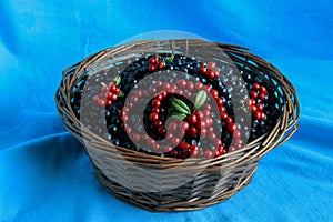 Delicious ripe blueberries in a wooden basket stands on table