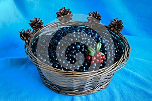 Delicious ripe blueberries in a wooden basket stands on table